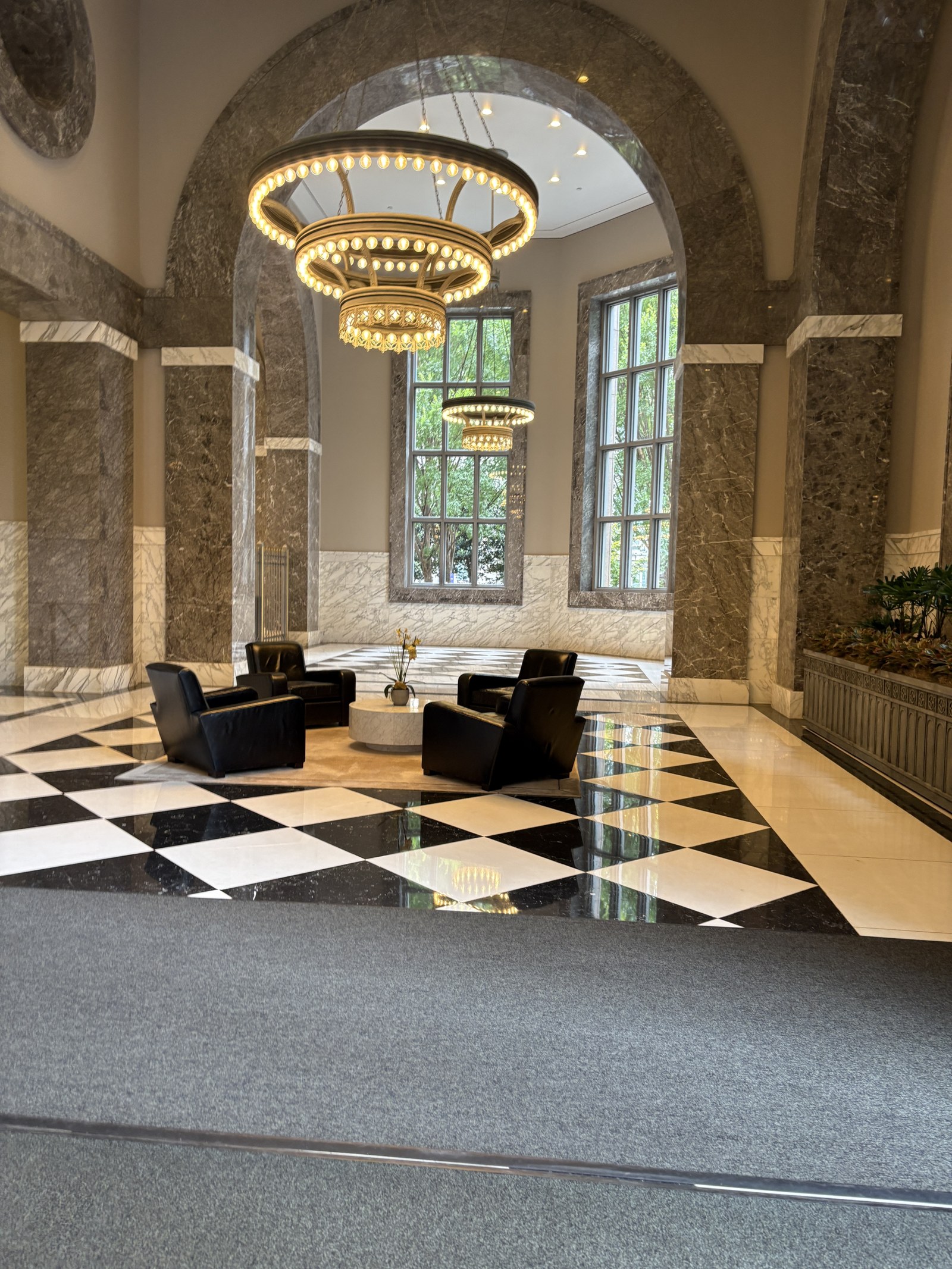 Grand arched lobby with chandelier and checkerboard marble floor at One Atlantic Center